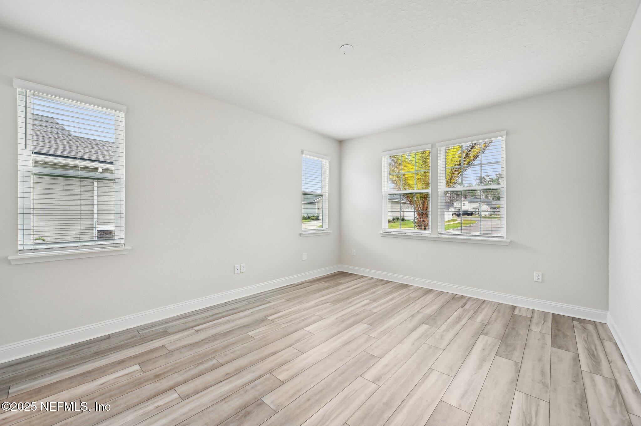 108 Wards Ravine Way St. Johns, FL 32259 - Photo 23 of 53 a view of an empty room with wooden floor and a window