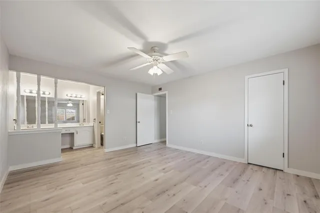 a view of an empty room with a kitchen