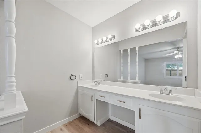 a bathroom with a double vanity sink and a mirror