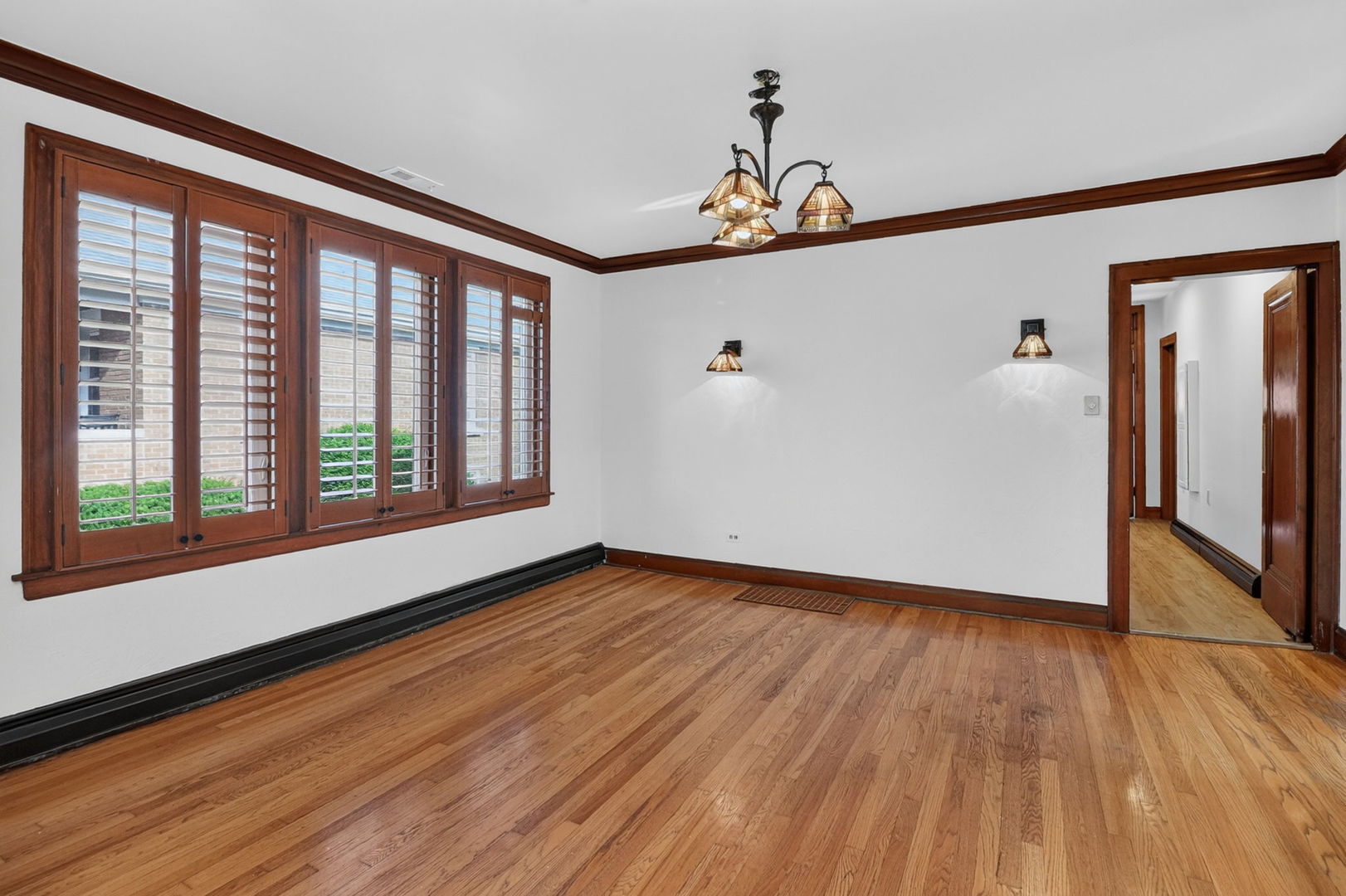 708 McCarthy Road Lemont, IL 60439 - Photo 4 of 14 a view of an empty room with wooden floor and a window