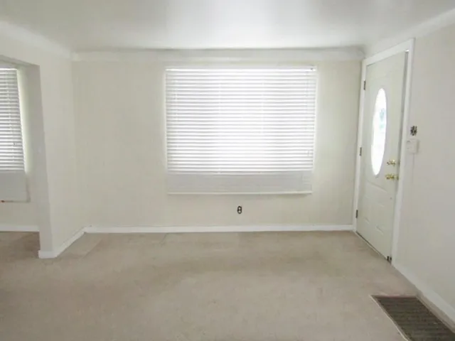 a view of an empty room with a window