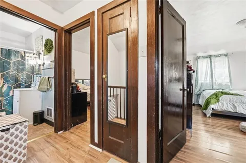 a bedroom with a bed and a mirror