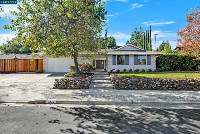 a front view of a house with a garden
