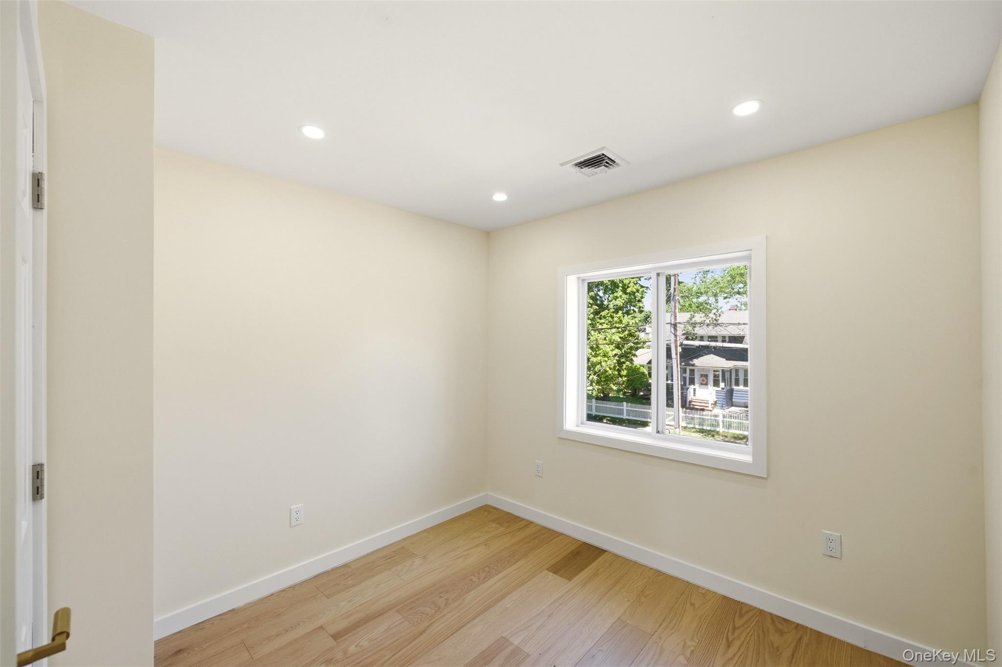 135 Whaley Street Freeport, NY 11520 - Photo 32 of 38 an empty room with a window