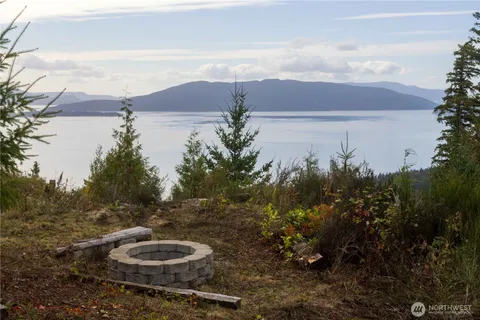a view of a chairs and table in backyard