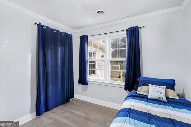 a bedroom with furniture and a window