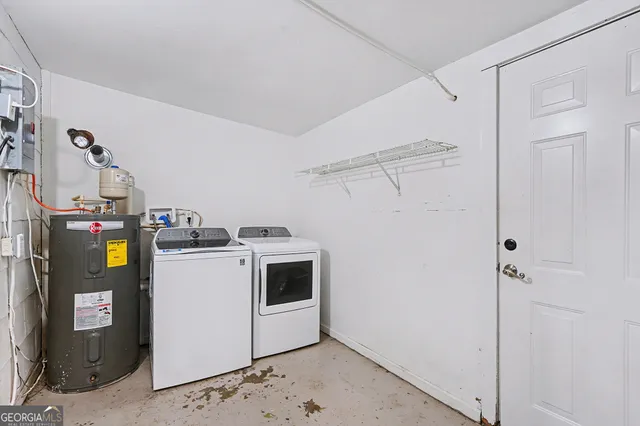 a view of storage and utility room with washer and dryer