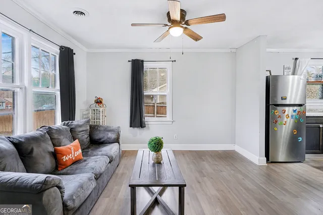 a living room with furniture and wooden floor