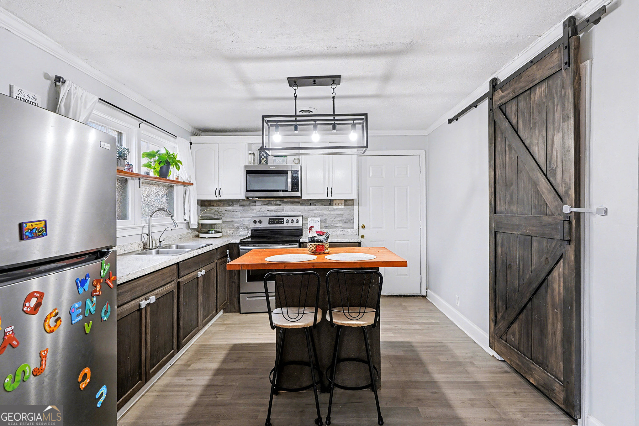 112 Oak Avenue Griffin, GA 30224 - Photo 6 of 16 a kitchen with stainless steel appliances granite countertop a sink stove and refrigerator
