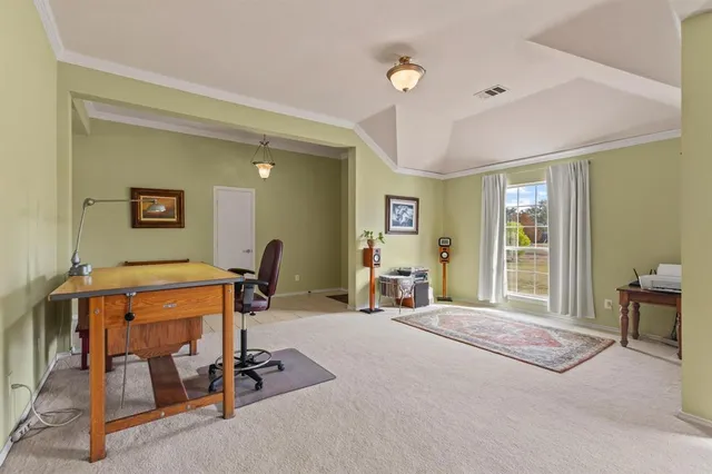 a dining room with furniture a rug and a chandelier