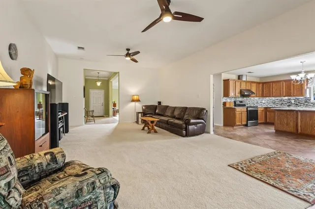 a kitchen with kitchen island granite countertop a stove sink and cabinets