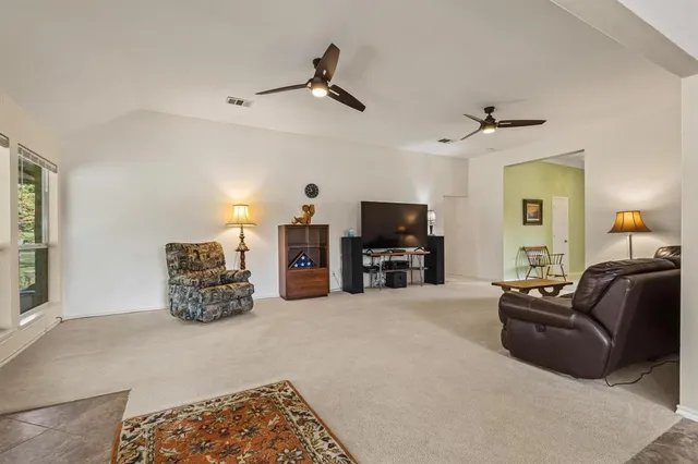 a kitchen with a stove a sink a center island and a window