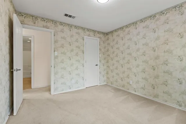 a bedroom with a bed a dresser and a book shelf