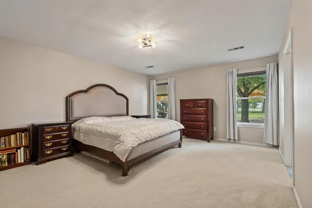 a bedroom with a bed and a mirror