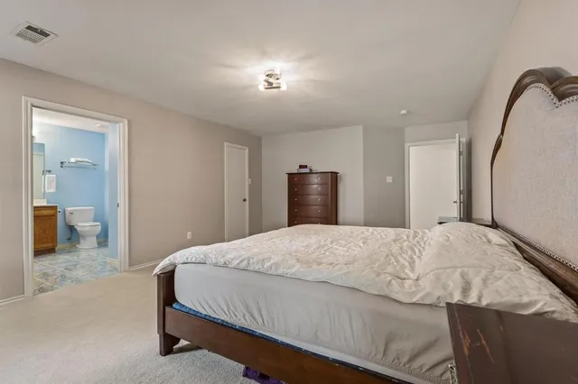 a bathroom with a granite countertop sink a toilet and a mirror
