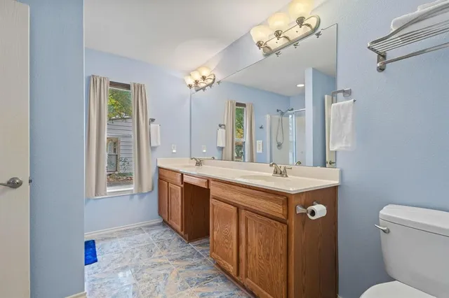 a bathroom with a glass shower door