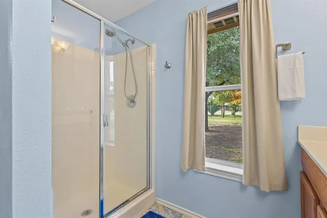 a view of a patio with a table and chairs under an umbrella
