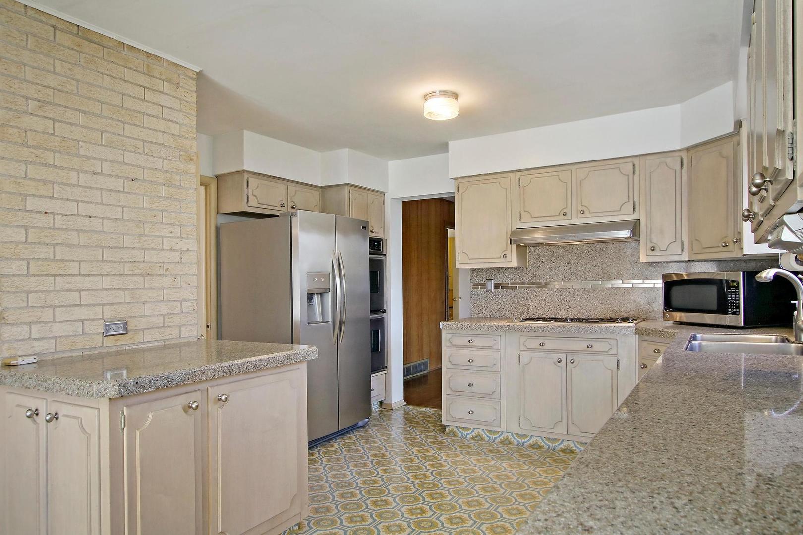 1155 Cayuga Drive Northbrook, IL 60062 - Photo 11 of 28 a kitchen with stainless steel appliances granite countertop a refrigerator a stove and white cabinets