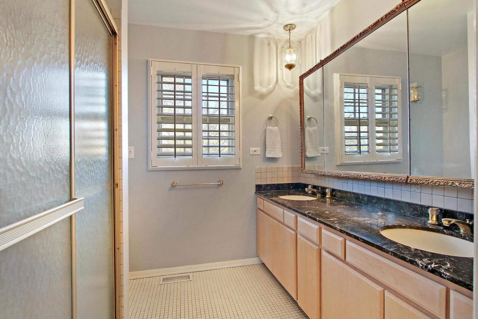 1155 Cayuga Drive Northbrook, IL 60062 - Photo 17 of 28 a kitchen with granite countertop a sink and a refrigerator