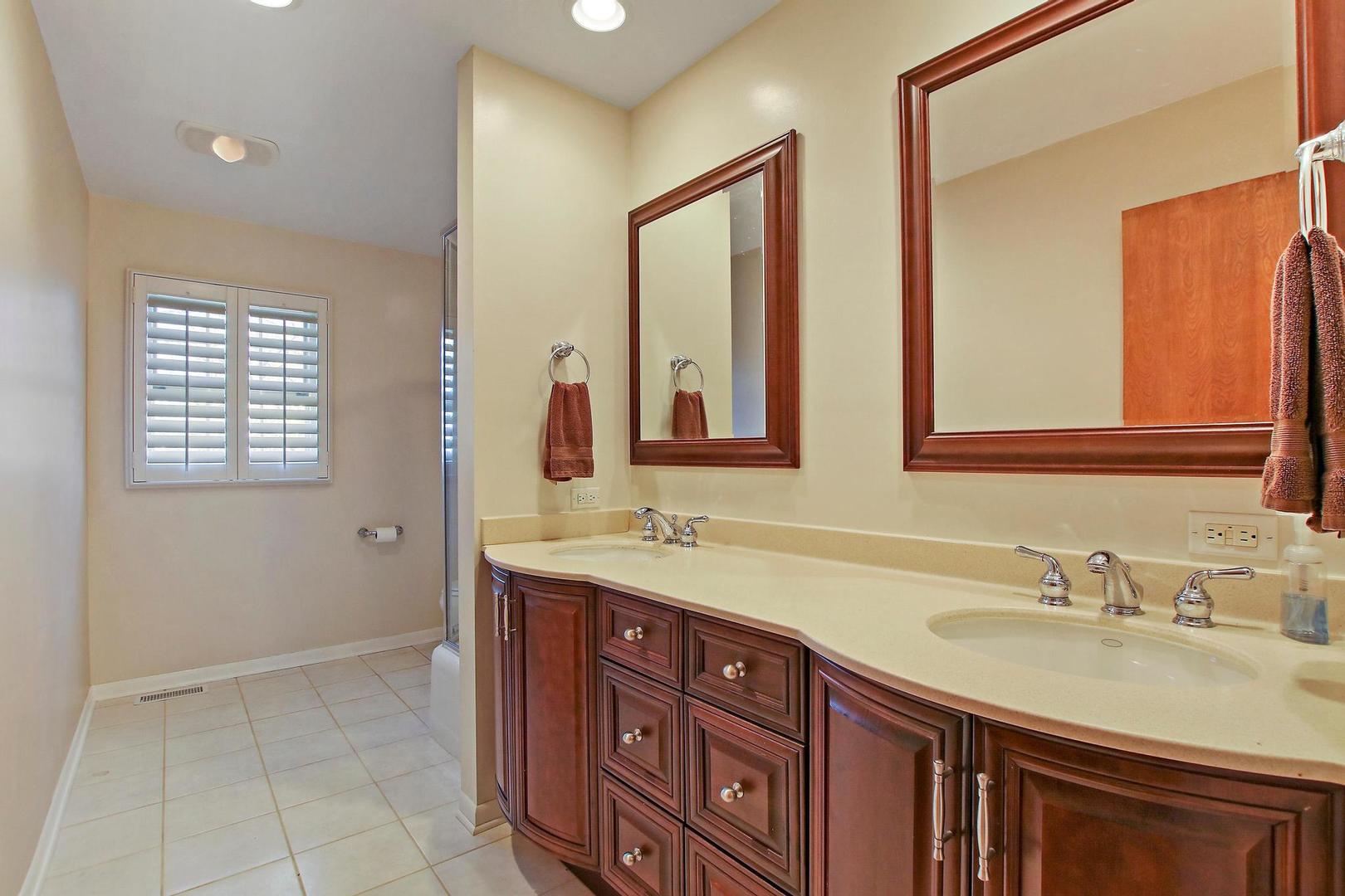 1155 Cayuga Drive Northbrook, IL 60062 - Photo 23 of 28 a bathroom with a sink double vanity and a mirror