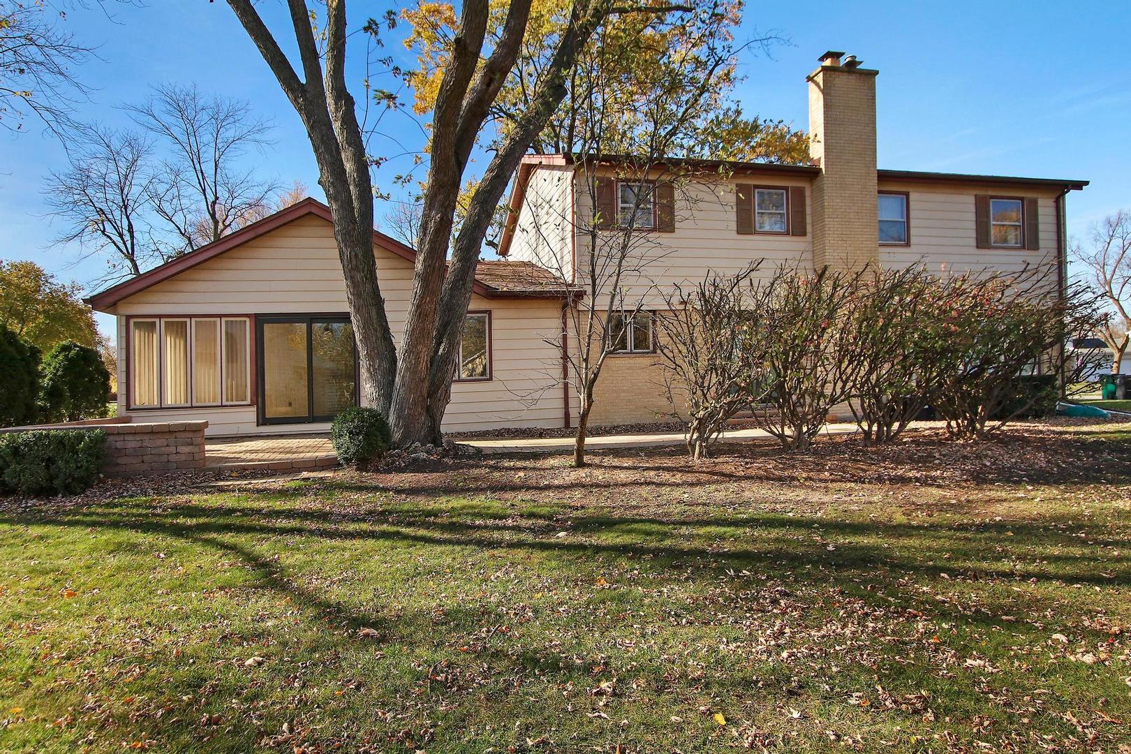 1155 Cayuga Drive Northbrook, IL 60062 - Photo 26 of 28 a front view of a house with a yard and garage