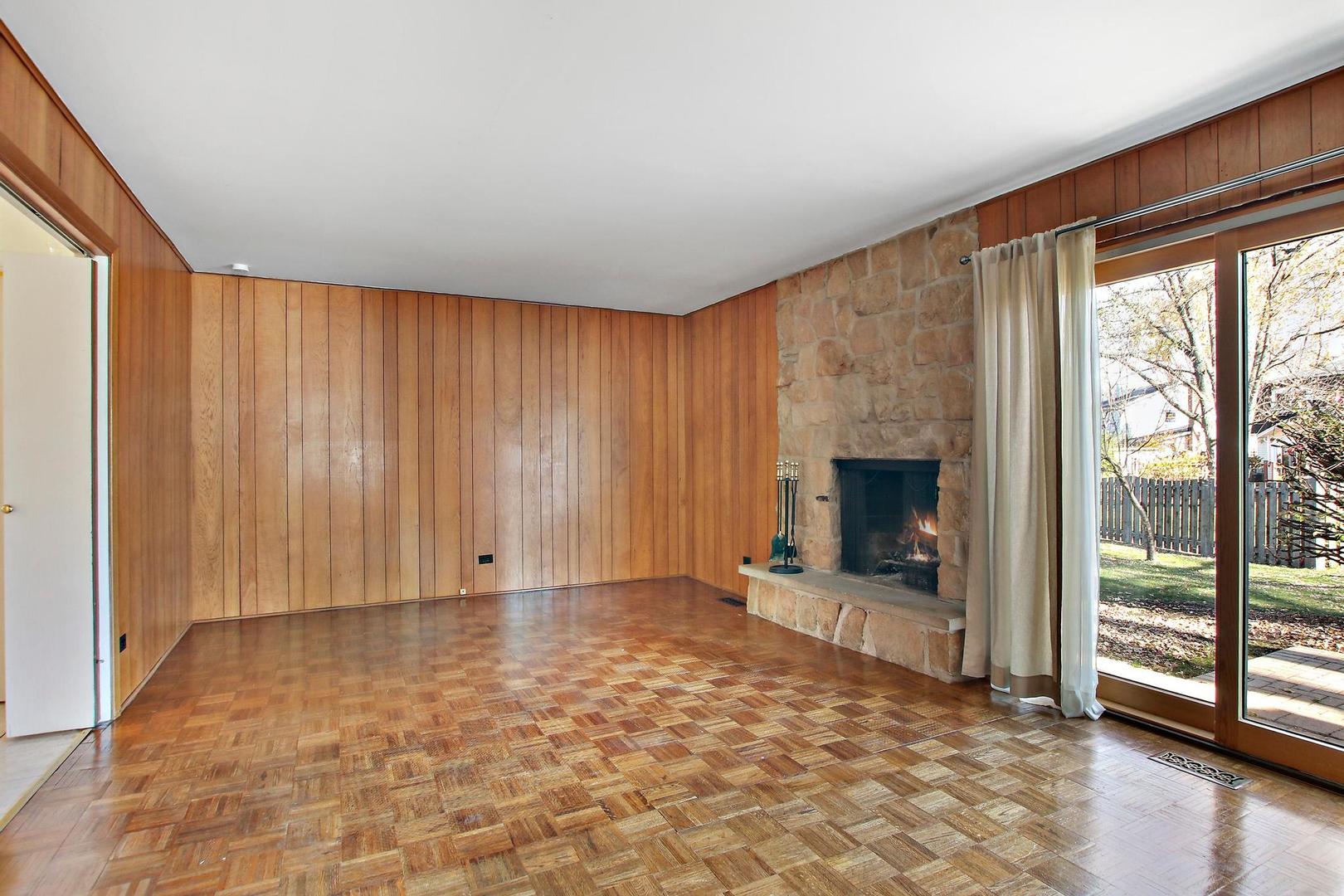 1155 Cayuga Drive Northbrook, IL 60062 - Photo 6 of 28 a view of an empty room with a fireplace and a window