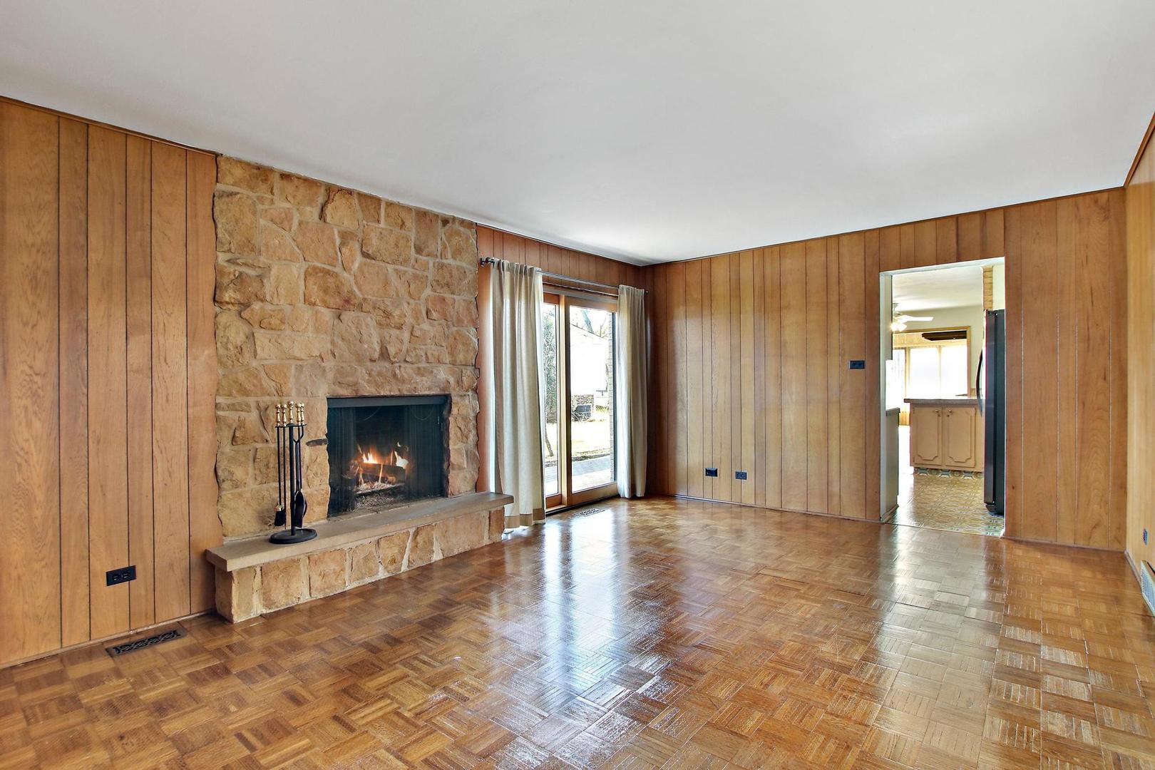 1155 Cayuga Drive Northbrook, IL 60062 - Photo 7 of 28 a view of an empty room with a fireplace and a window