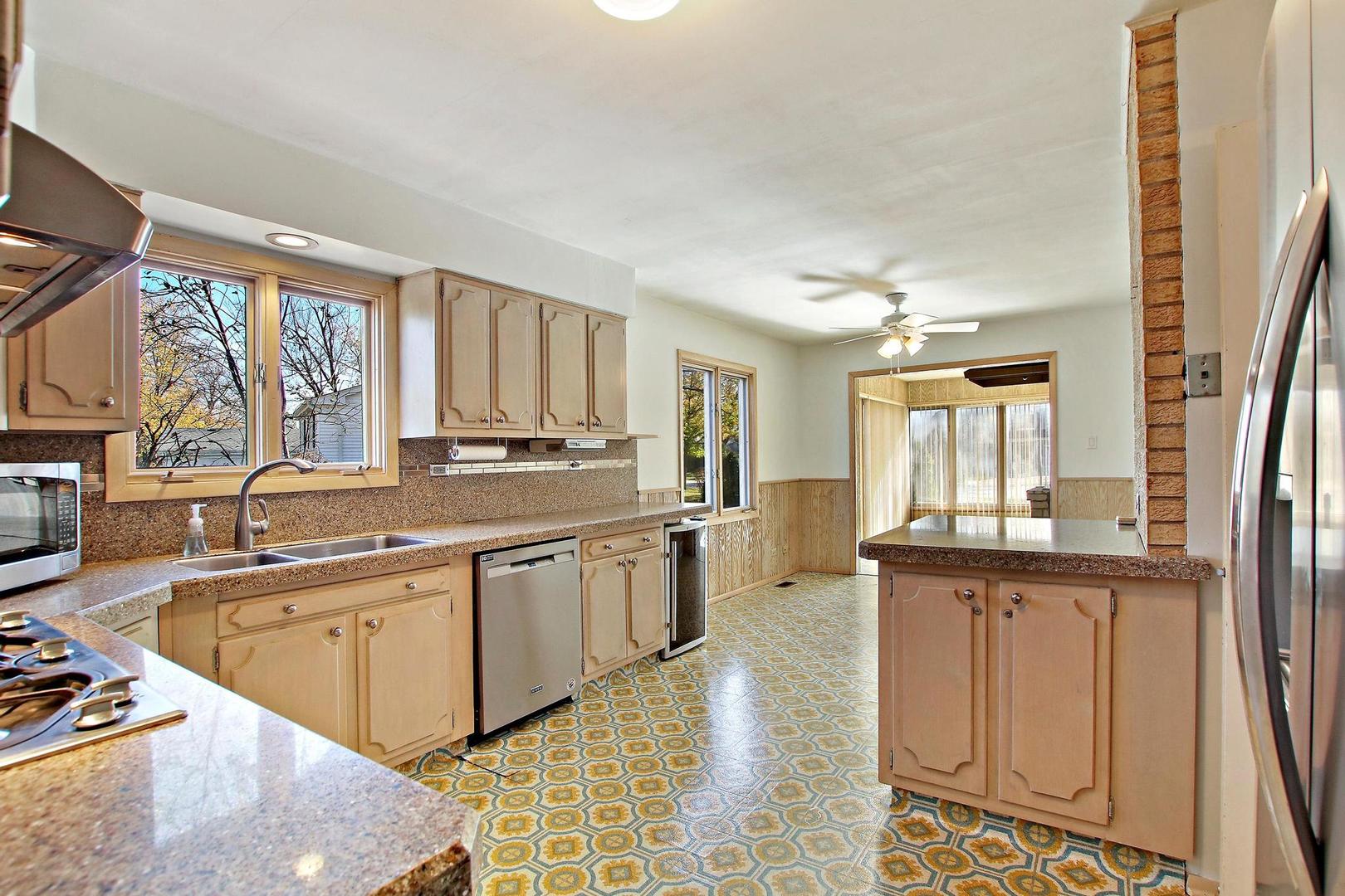 1155 Cayuga Drive Northbrook, IL 60062 - Photo 8 of 28 a kitchen with stainless steel appliances granite countertop a sink and a stove