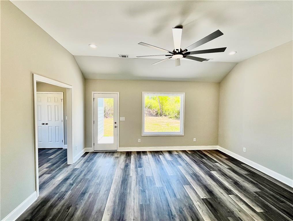 5 Green Road Griffin, GA 30224 - Photo 31 of 34 an empty room with wooden floor fan and windows