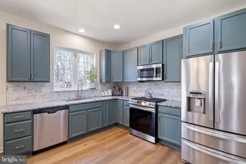 a kitchen with a refrigerator sink and microwave