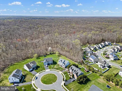 an aerial view of a house with yard swimming pool and outdoor seating