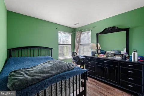 a bed sitting in a bedroom next to a window