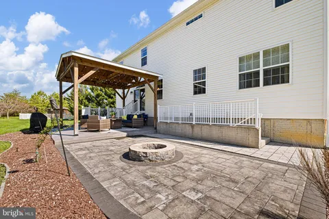 a view of outdoor living space with furniture and garden