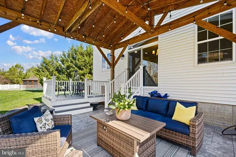 a outdoor living space with patio furniture and a garden