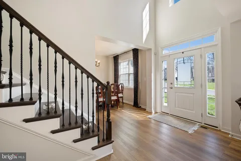 a balcony with chairs and wooden floor