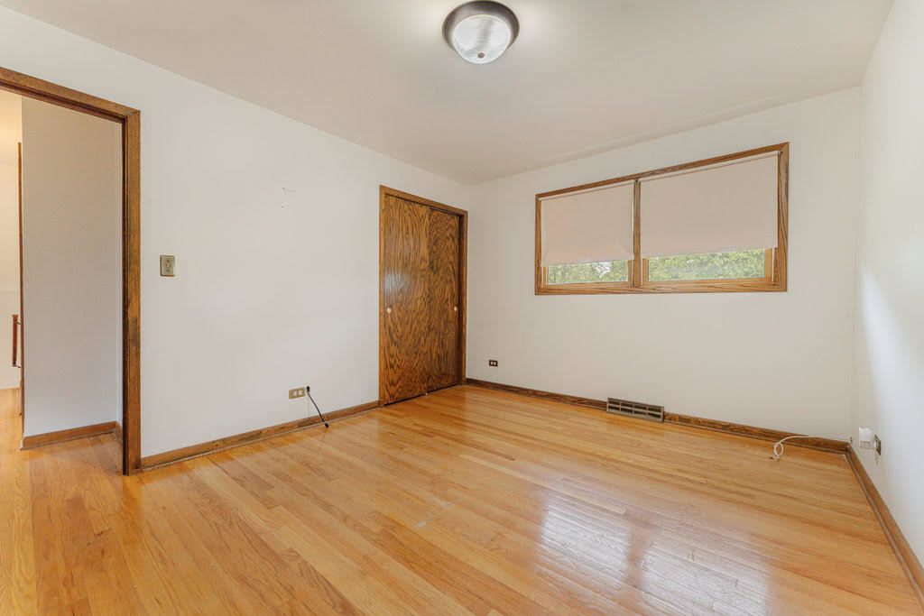 14322 McCarthy Road Lemont, IL 60439 - Photo 15 of 37 an empty room with wooden floor and windows