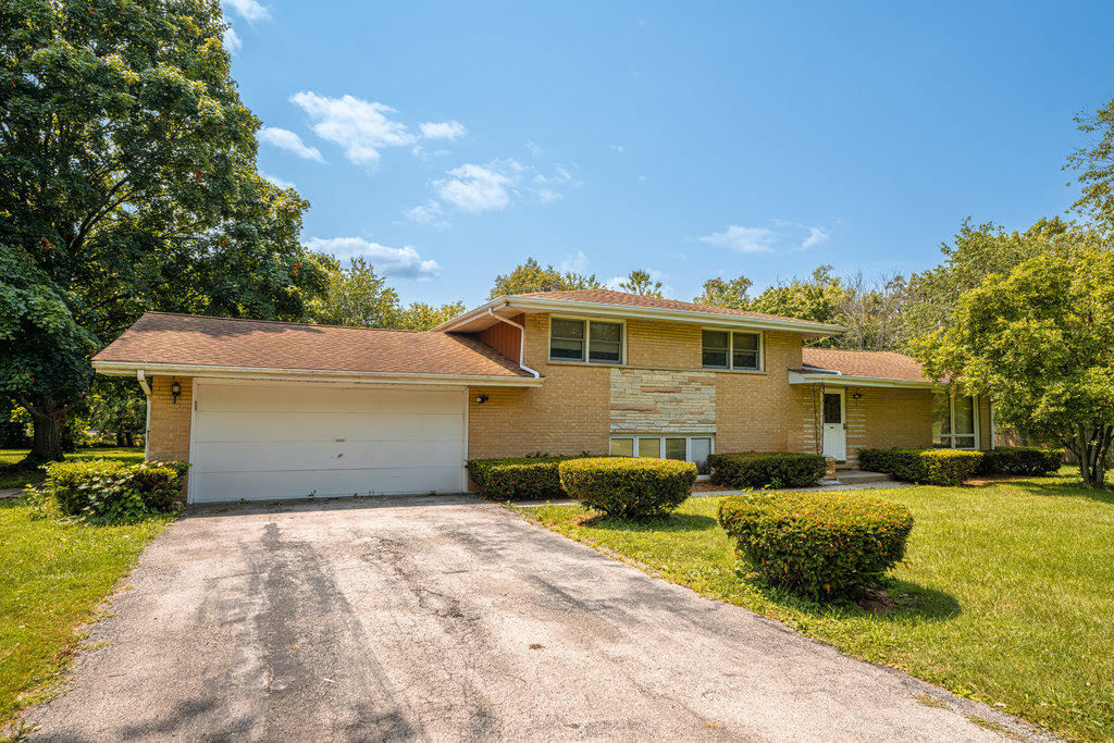14322 McCarthy Road Lemont, IL 60439 - Photo 23 of 37 a front view of a house with a yard and garage