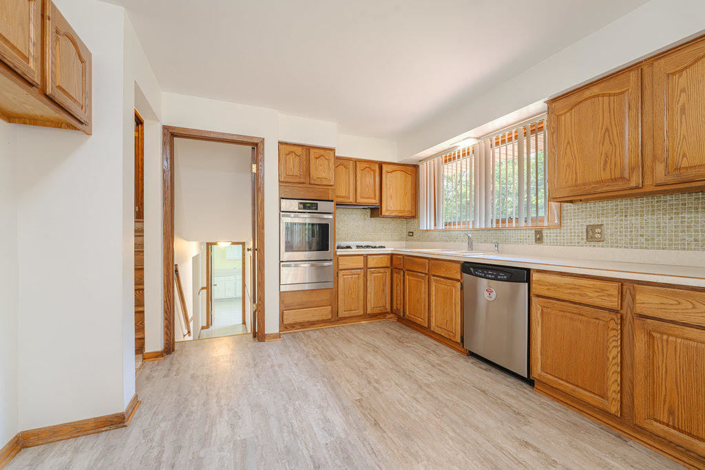 14322 McCarthy Road Lemont, IL 60439 - Photo 9 of 37 a kitchen with stainless steel appliances granite countertop a refrigerator sink and cabinets