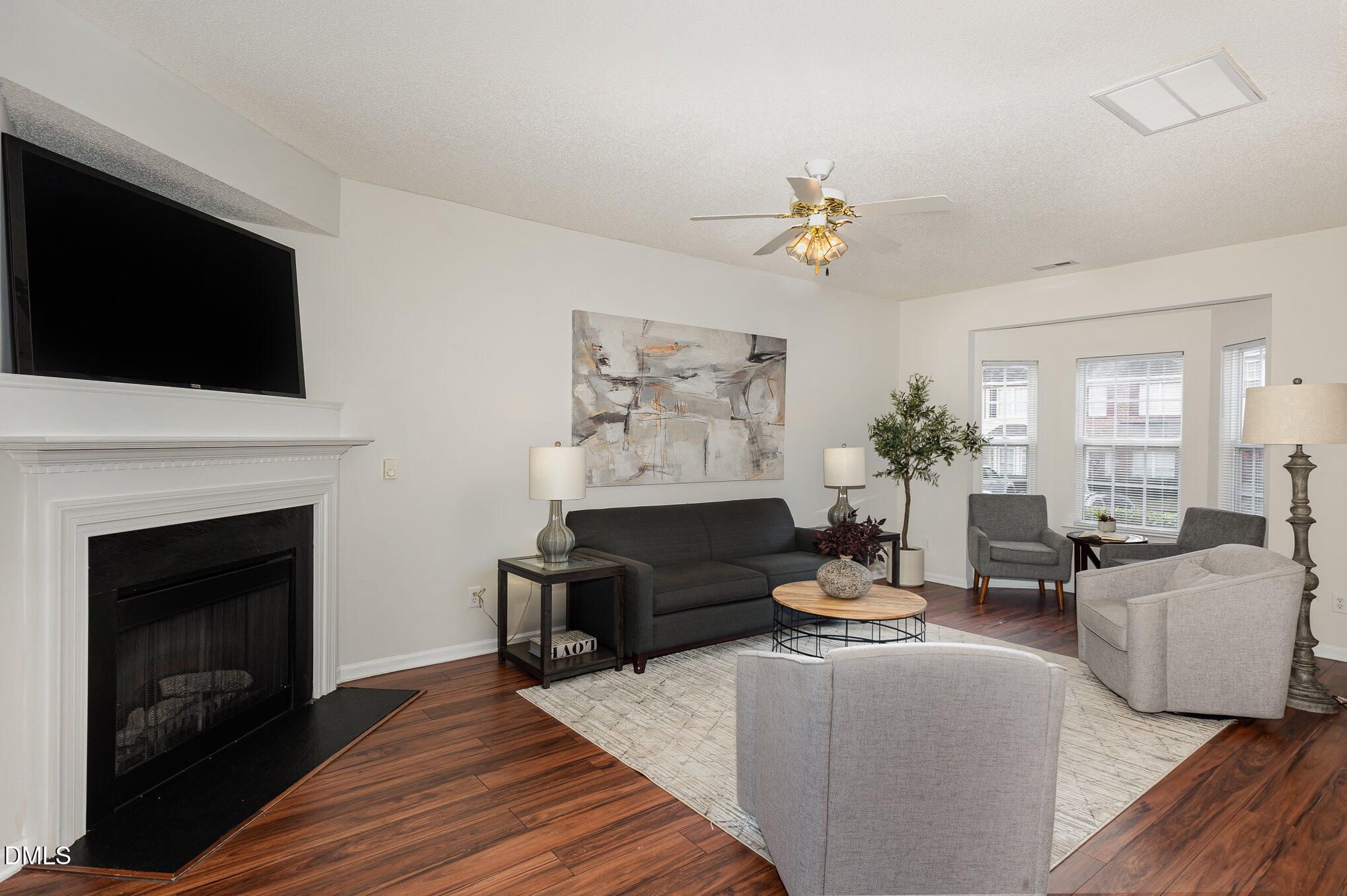 10947 Pendragon Place Raleigh, NC 27614 - Photo 2 of 21 a living room with furniture a fireplace and a flat screen tv