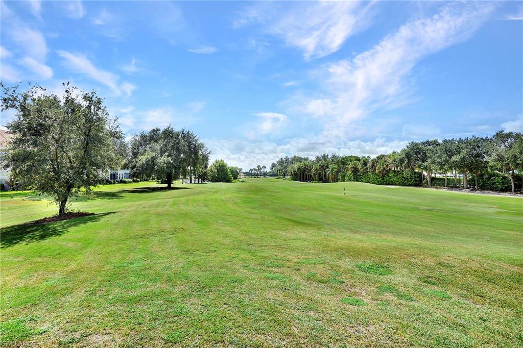 2015 Crestview Way, Unit 17B Naples, FL 34119 - Photo 22 of 29 a view of a green field with trees in the background