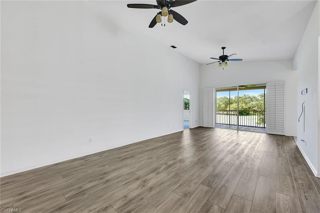 2015 Crestview Way, Unit 17B Naples, FL 34119 - Photo 5 of 29 wooden floor in an empty room with a window