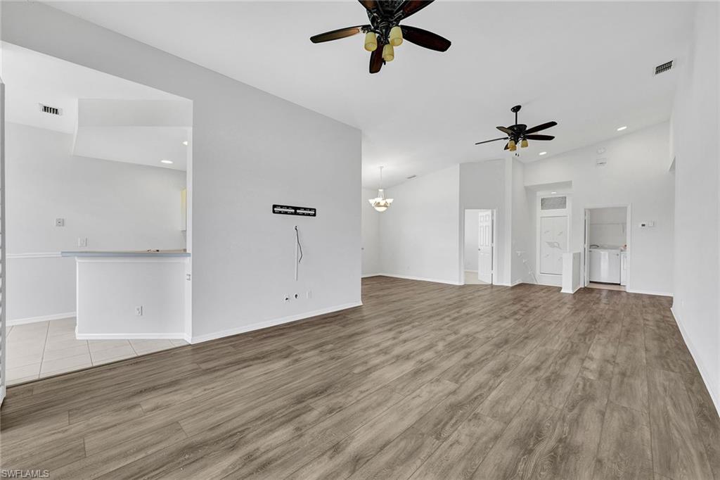 2015 Crestview Way, Unit 17B Naples, FL 34119 - Photo 6 of 29 wooden floor in an empty room with a window