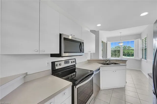 a kitchen with a stove a sink and a microwave