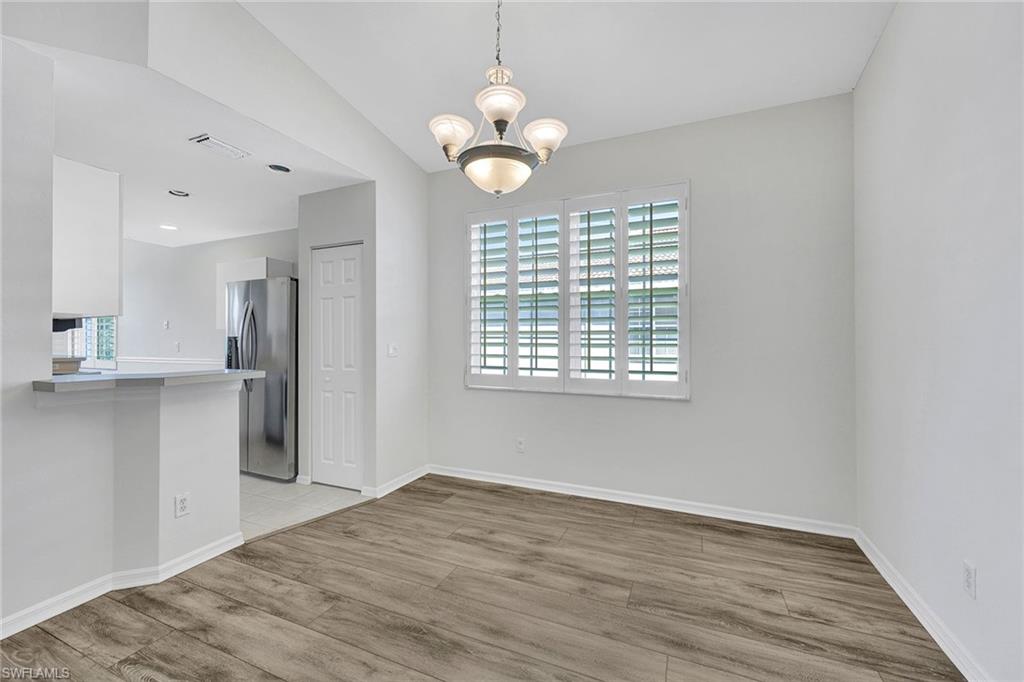 2015 Crestview Way, Unit 17B Naples, FL 34119 - Photo 10 of 29 an empty room with wooden floor and windows