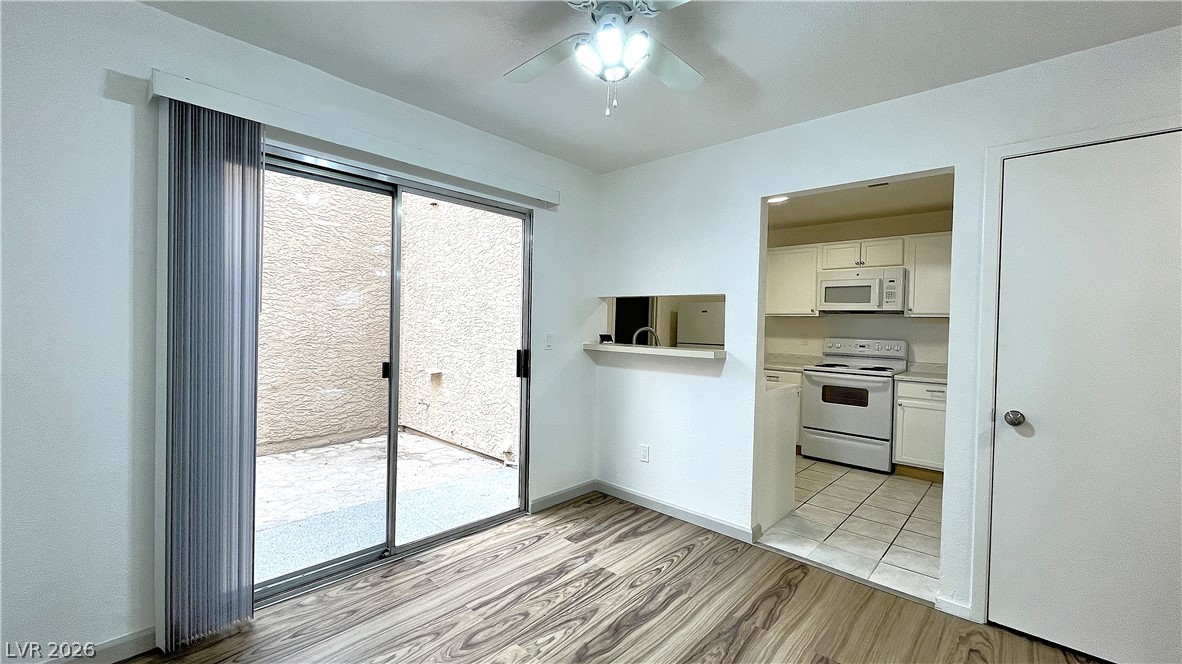 6750 Del Rey Avenue, Unit 123 Las Vegas, NV 89146 - Photo 6 of 21 A welcoming dining area features durable vinyl flooring and a sliding glass door leading to a private outdoor space.
