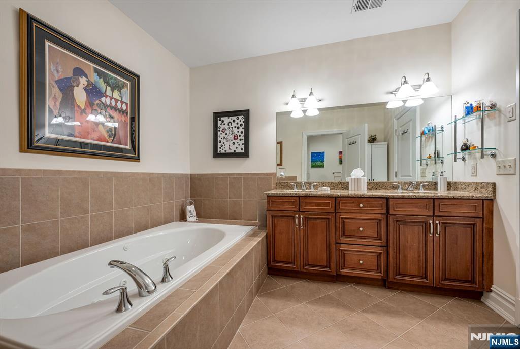 2310 Rio Vista Lane, Unit 2310 Northvale, NJ 07647 - Photo 20 of 49 a spacious bathroom with a tub a double vanity sink and a mirror