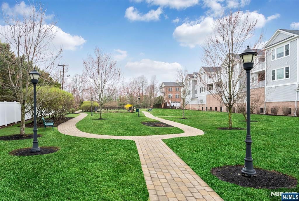 2310 Rio Vista Lane, Unit 2310 Northvale, NJ 07647 - Photo 34 of 49 a view of a fountain in front of a brick building