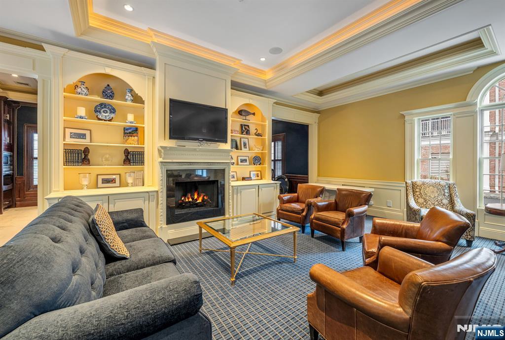 2310 Rio Vista Lane, Unit 2310 Northvale, NJ 07647 - Photo 38 of 49 a living room with furniture a flat screen tv and a fireplace