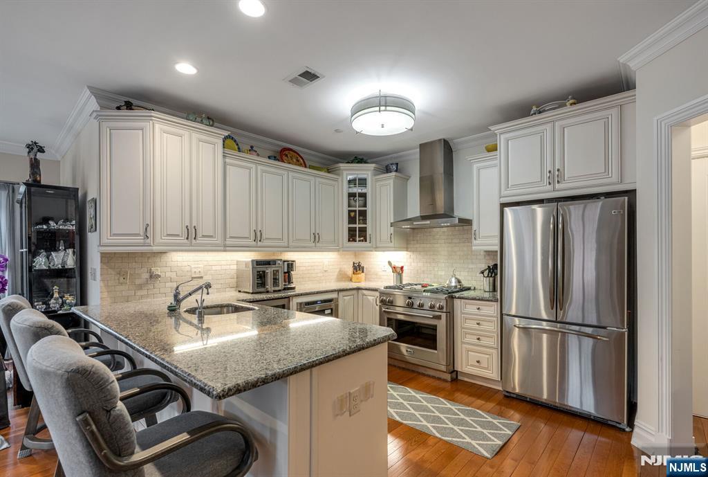 2310 Rio Vista Lane, Unit 2310 Northvale, NJ 07647 - Photo 9 of 49 a kitchen with stainless steel appliances granite countertop a sink refrigerator and cabinets
