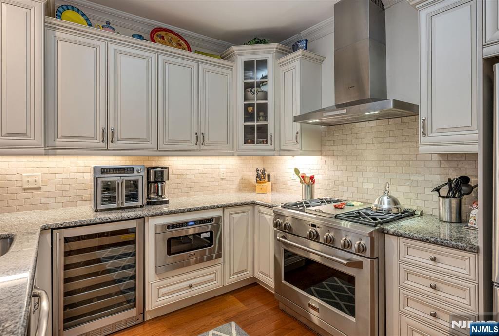 2310 Rio Vista Lane, Unit 2310 Northvale, NJ 07647 - Photo 10 of 49 a kitchen with granite countertop a stove oven and white cabinets